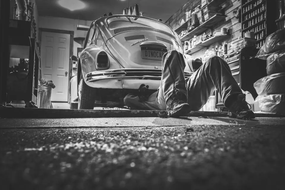 Mechanic working on a car in a shop